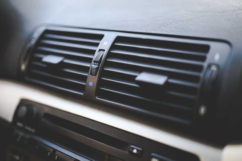 Air conditioning service gauges connected to a vehicle