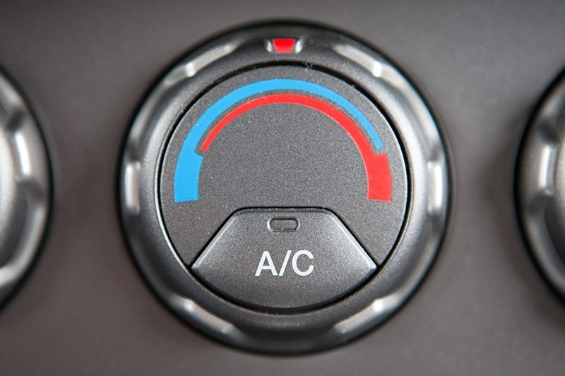 Air conditioning service gauges connected to a vehicle