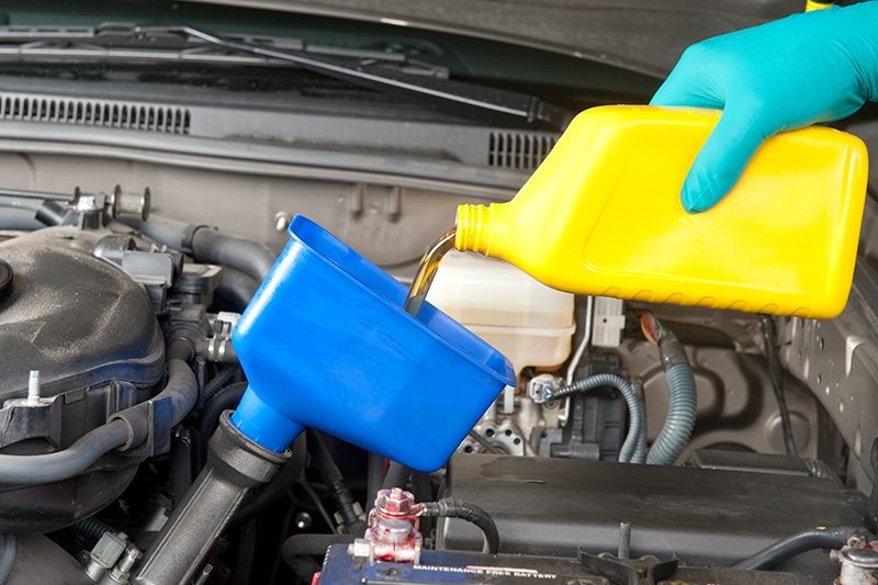 Oil and filter change being carried out on a vehicle lift