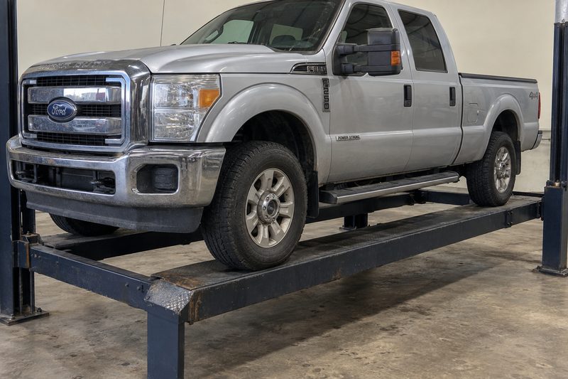 A Ford F-250 Power Stroke on the lift at Dakota Ridge Auto in Littleton
