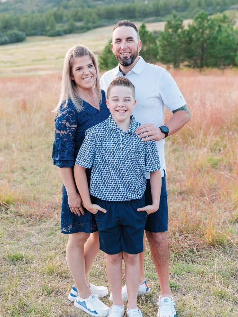 TJ Cobbett, owner of Dakota Ridge Auto, with his wife and son