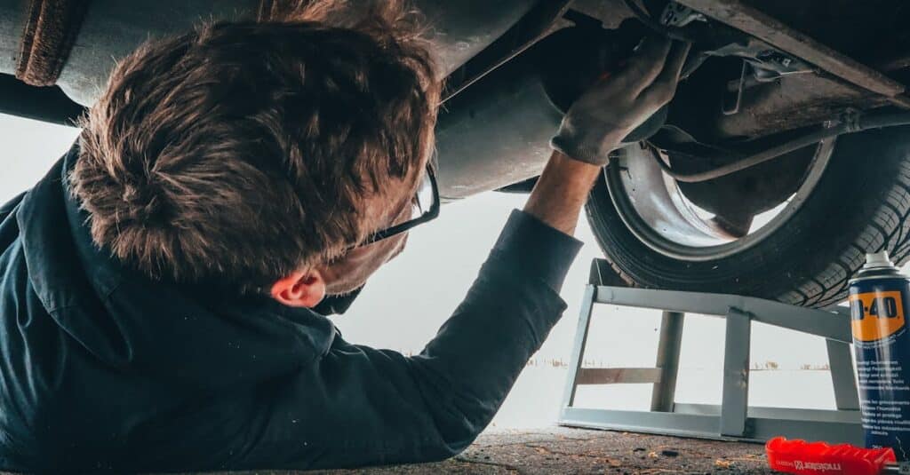 mechanic-skillfully-repairing-car-undercarriage-in-outdoor-setting-with-tools - Dakota Ridge Auto