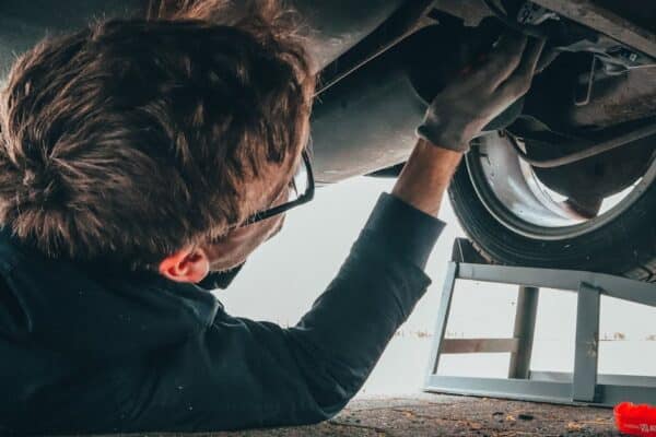 mechanic-skillfully-repairing-car-undercarriage-in-outdoor-setting-with-tools - Dakota Ridge Auto